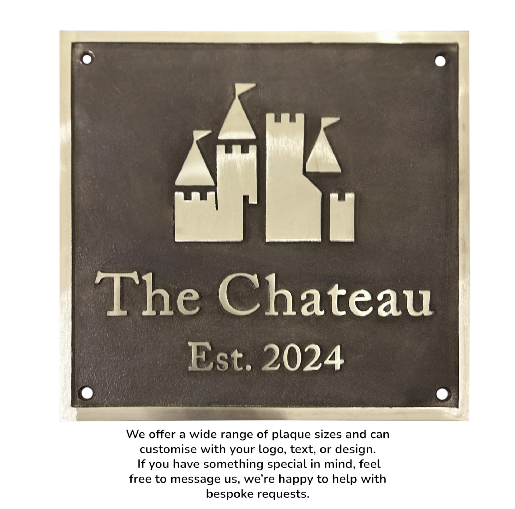 Decorative plaque with castle design and 'The Chateau Est. 2024' text on a bronze background.