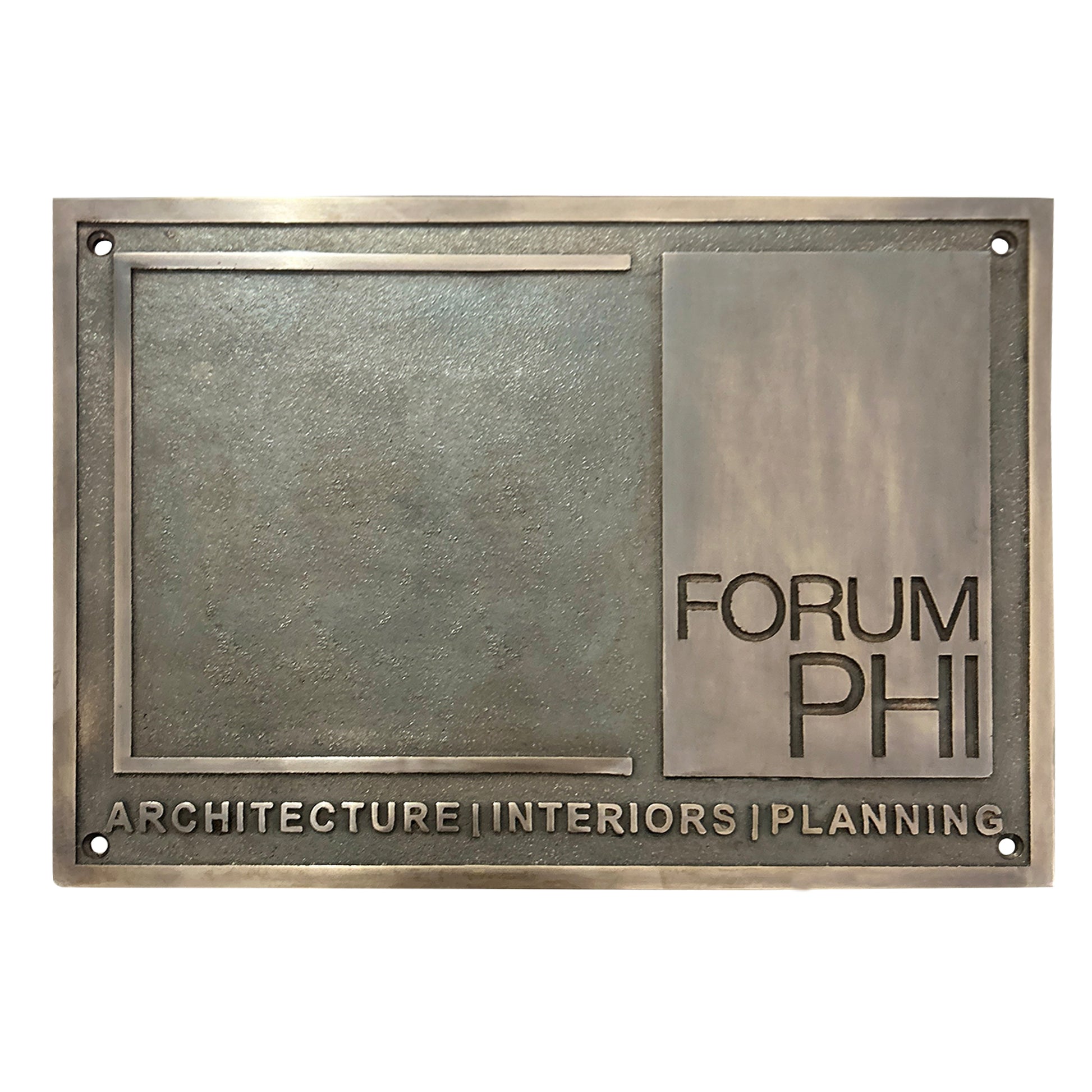Metal plaque with 'FORUM PHI' and 'Architecture Interiors Planning' text on a white background
